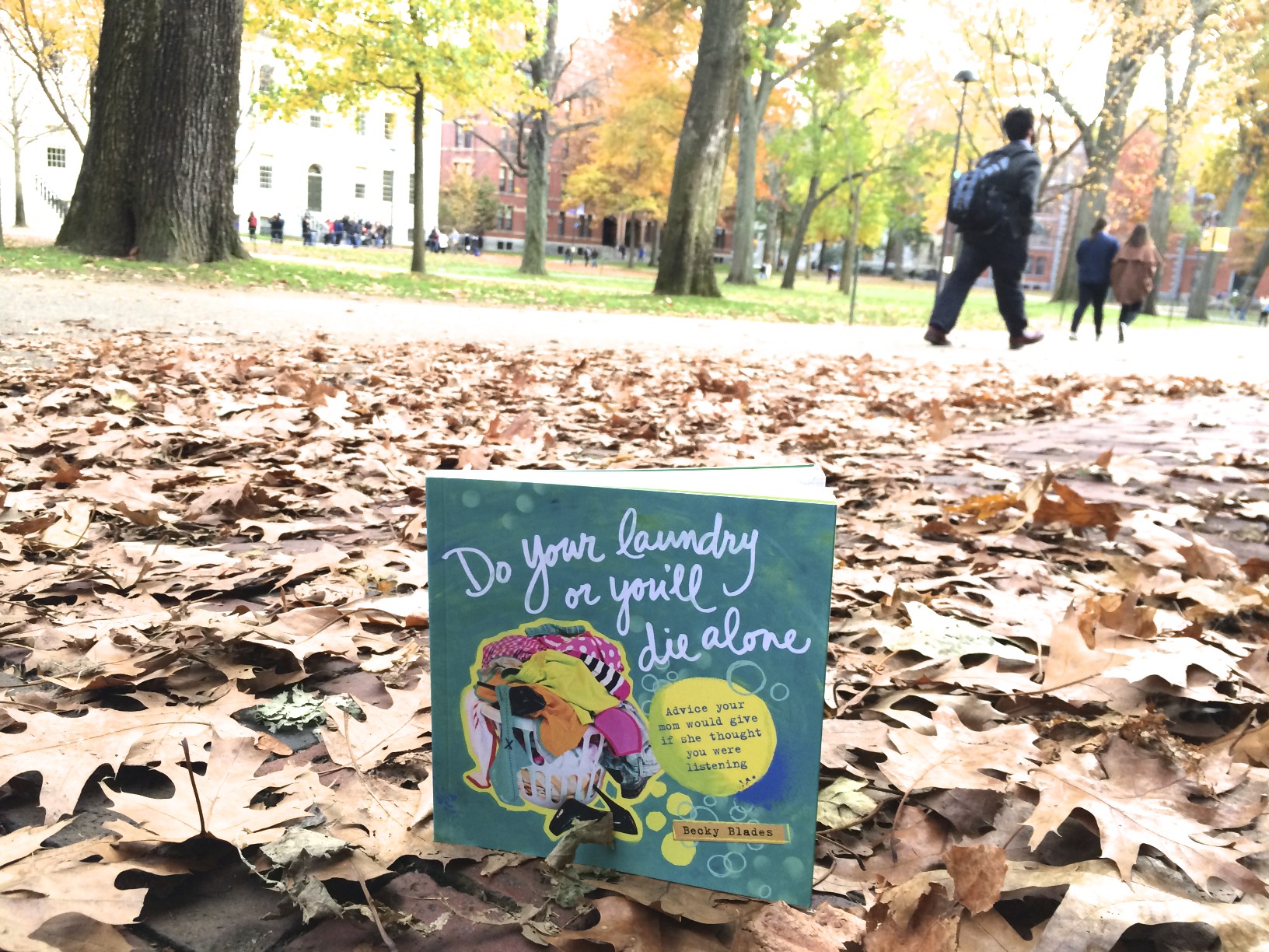  do your laundry or you'll die alone book on fall leaves in front of college campus