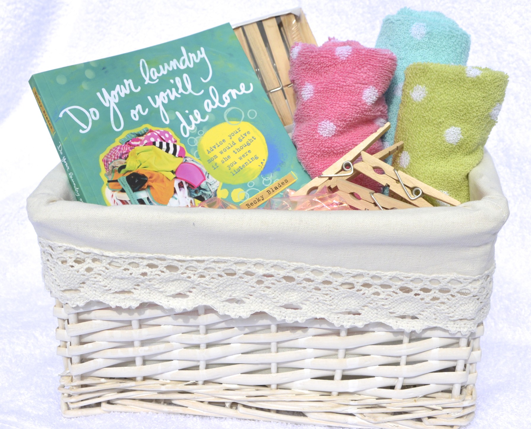 do your laundry or you'll die alone book in pretty laundry basket with towels and clothespins